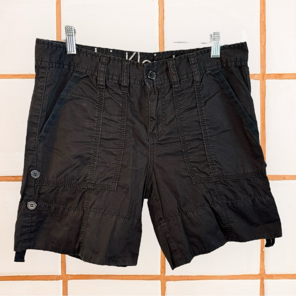 black cotton cargo shorts with a relaxed fit, button fly, and side pockets